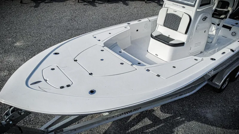 Slide: The Image of 2026 Tidewater 2410 Bay Max boat on trailer, featuring spacious deck and seating. - 9