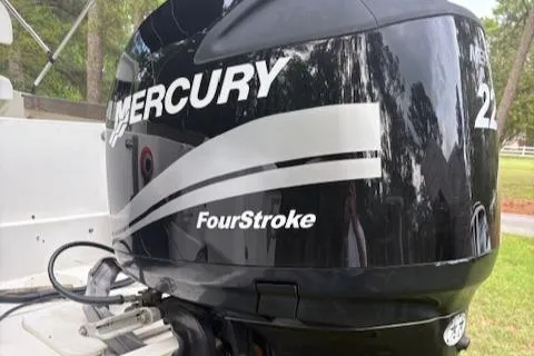 Slide: The Image of 1977 Aquasport 222 boat with Mercury FourStroke engine, outdoor setting. - 10