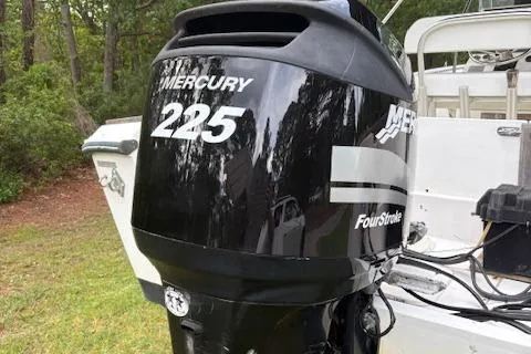 Slide: The Image of 1977 Aquasport 222 boat with Mercury 225 FourStroke engine, parked on grass. - 13