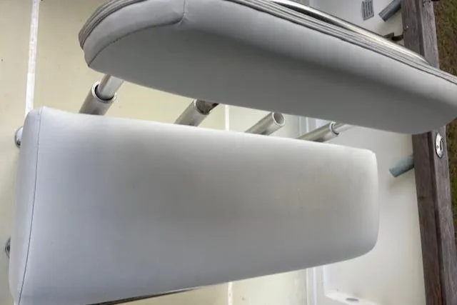 Slide: The Image of 1977 Aquasport 222 boat seat with white upholstery and metal supports. - 15