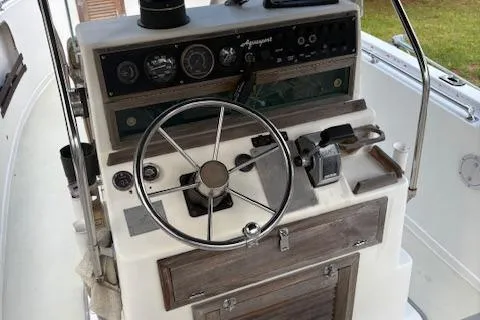 Slide: The Image of 1977 Aquasport 222 boat dashboard with steering wheel and control panel. - 6