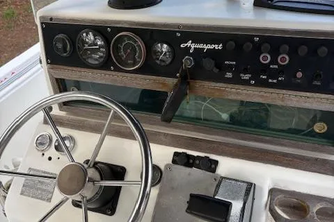 Slide: The Image of 1977 Aquasport 222 boat dashboard with steering wheel and control panel. - 7
