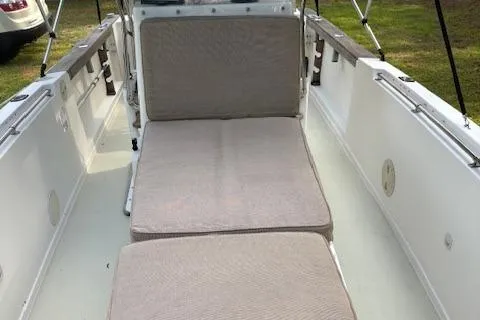 Slide: The Image of 1977 Aquasport 222 boat interior with cushioned seating and white deck. - 8