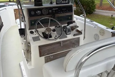 Slide: The Image of 1977 Aquasport 222 boat interior with steering wheel and control panel. - 9
