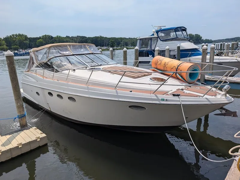 The Image of 2002 Regal Commodore 3860 yacht docked at marina with clear skies. - 0