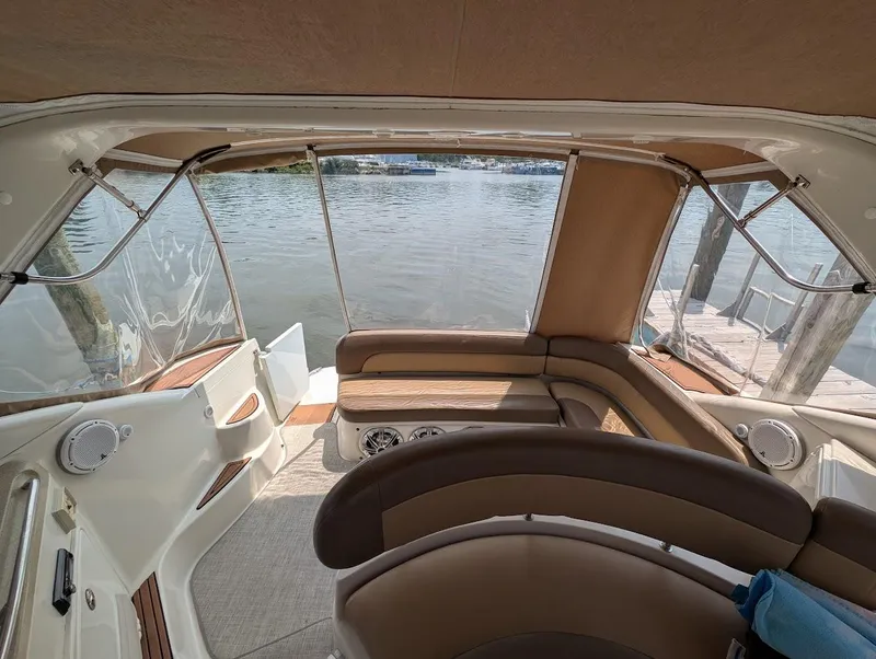 Slide: The Image of Interior view of 2002 Regal Commodore 3860 yacht with seating and water backdrop. - 11