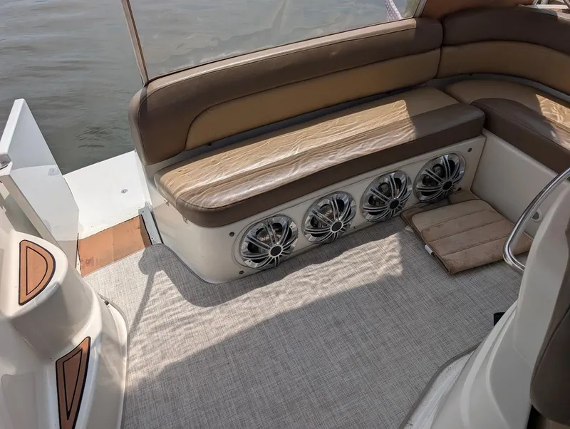 Slide: The Image of Interior of 2002 Regal Commodore 3860 boat with brown seating and built-in speakers. - 12