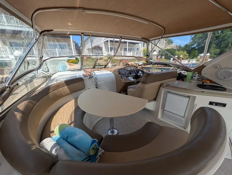 Slide: The Image of Interior of 2002 Regal Commodore 3860 yacht with seating and helm. - 13