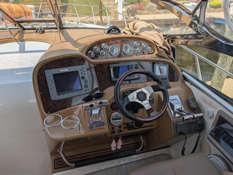 Slide: The Image of 2002 Regal Commodore 3860 boat dashboard with steering wheel and navigation controls. - 16