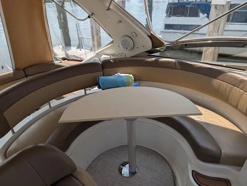Slide: The Image of Interior of 2002 Regal Commodore 3860 yacht with curved seating and table. - 17