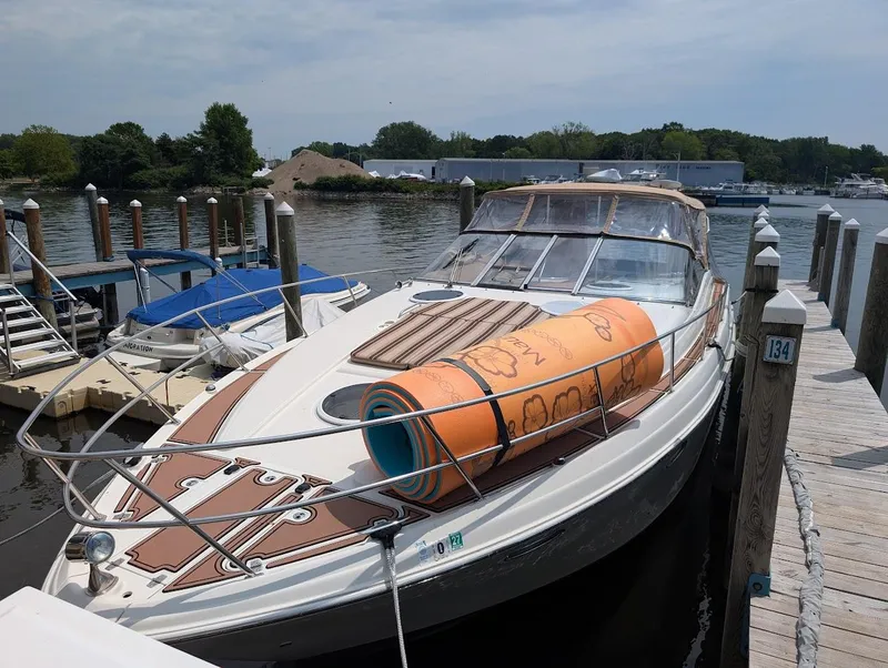 Slide: The Image of 2002 Regal Commodore 3860 yacht docked with an orange float on deck. - 2