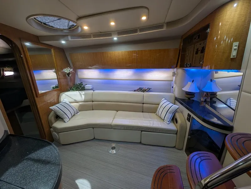Slide: The Image of Luxurious interior of 2002 Regal Commodore 3860 yacht with plush seating and ambient lighting. - 21