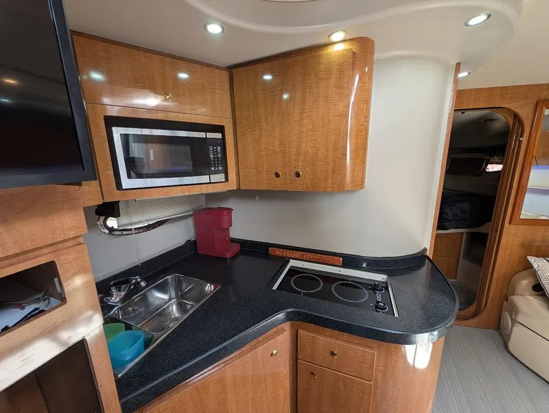 Slide: The Image of Interior of 2002 Regal Commodore 3860 yacht kitchen with microwave and stove. - 27