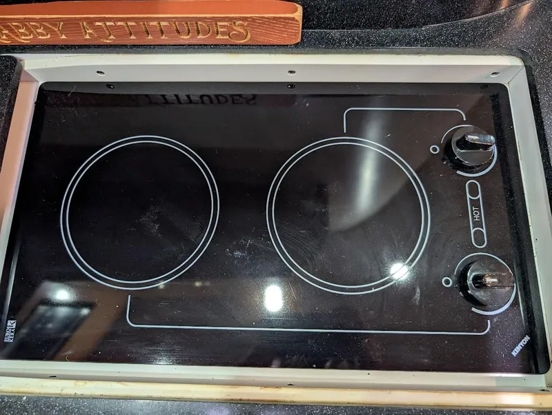Slide: The Image of Ceramic cooktop on 2002 Regal Commodore 3860 boat, featuring dual burners and control knobs. - 28