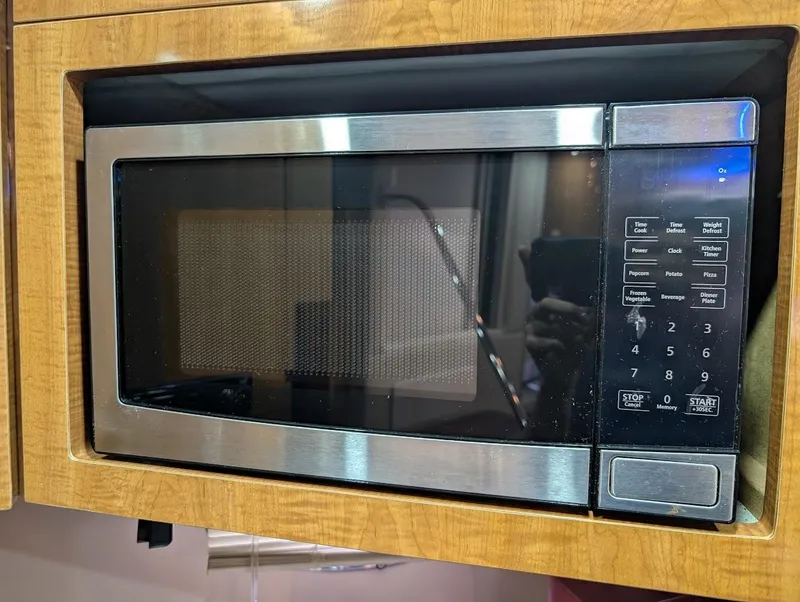 Slide: The Image of Built-in microwave oven with digital controls in a wooden cabinet. - 29
