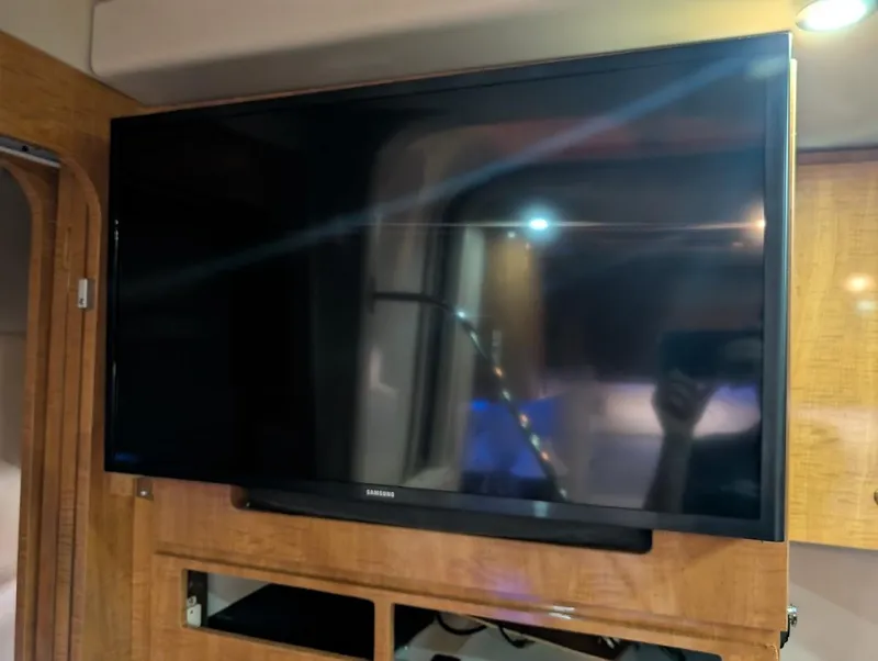 Slide: The Image of Flat-screen TV inside 2002 Regal Commodore 3860 yacht interior. - 30