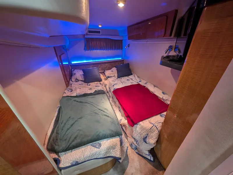 Slide: The Image of Interior of 2002 Regal Commodore 3860 yacht with twin beds and ambient lighting. - 36