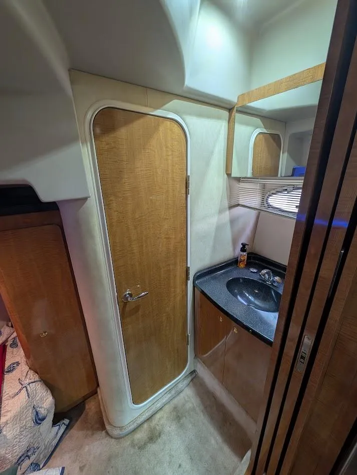 Slide: The Image of 2002 Regal Commodore 3860 yacht interior with wooden door and compact bathroom sink. - 37