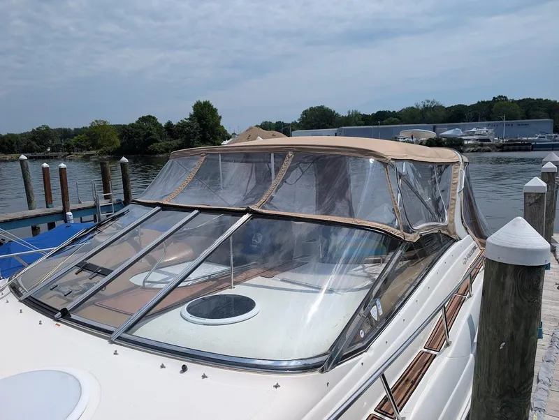 Slide: The Image of 2002 Regal Commodore 3860 yacht docked by a serene waterfront. - 4