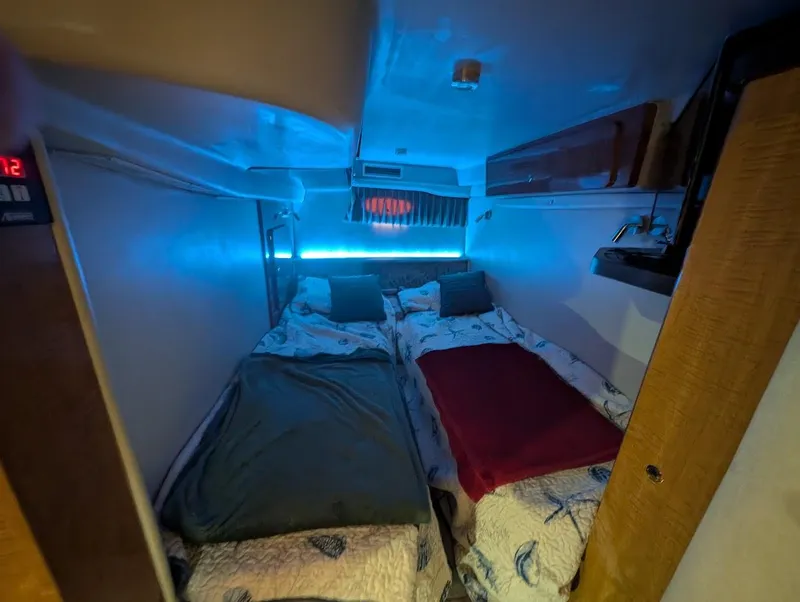 Slide: The Image of Interior cabin of 2002 Regal Commodore 3860 with cozy twin beds and ambient lighting. - 40