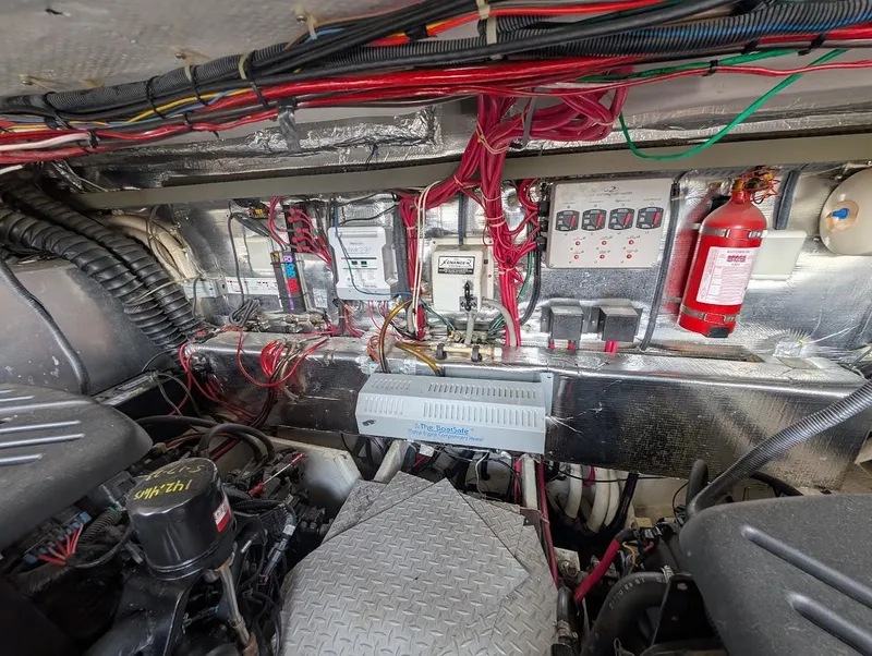 Slide: The Image of Engine room of a 2002 Regal Commodore 3860 with wiring and fire extinguisher. - 45