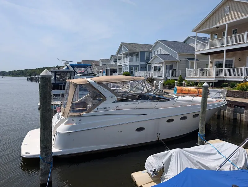Slide: The Image of 2002 Regal Commodore 3860 yacht docked near waterfront homes. - 5