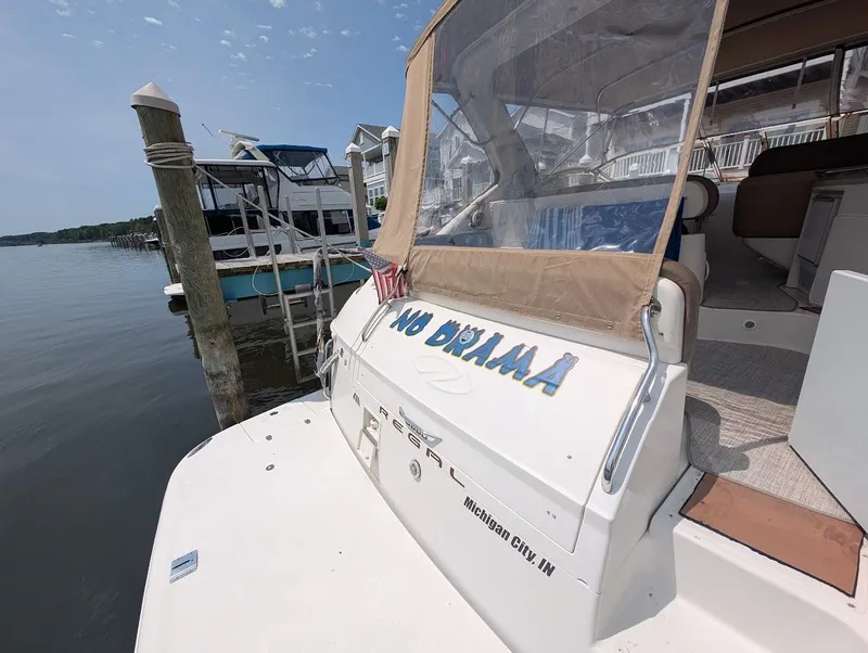 Slide: The Image of 2002 Regal Commodore 3860 boat docked, featuring "No Drama" text on the stern. - 7