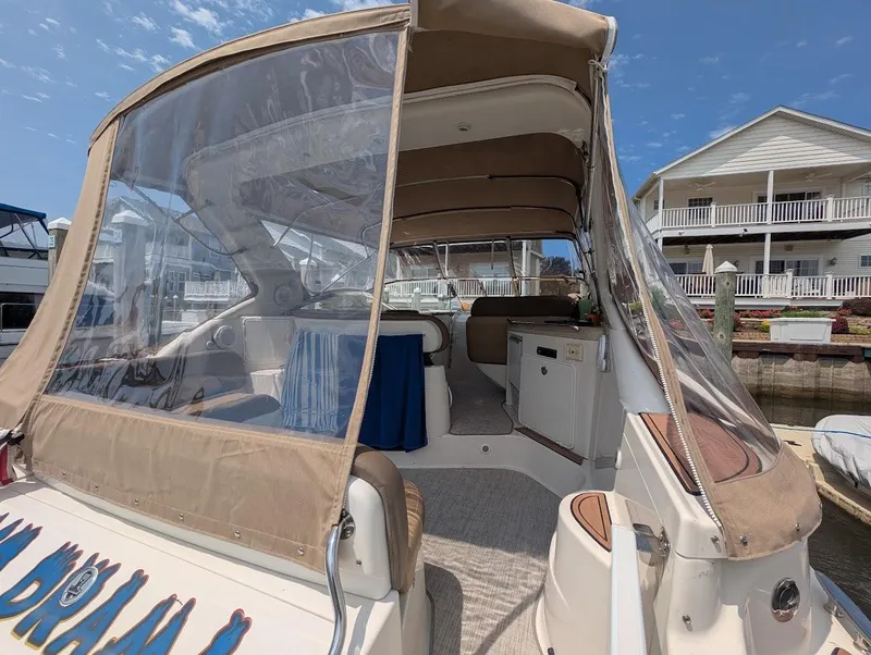 Slide: The Image of 2002 Regal Commodore 3860 yacht with covered seating area at a marina. - 9