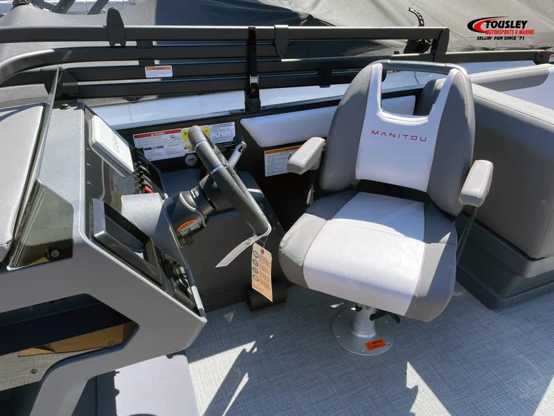 Slide: The Image of Captain's chair and helm of 2025 Manitou Cruise 20 MAX Bench Twin Tube boat. - 5
