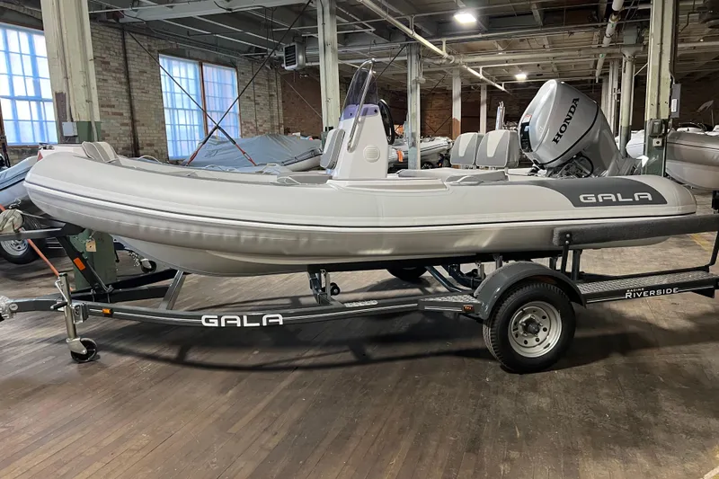 Slide: The Image of 2026 Gala V420 inflatable boat on trailer in industrial setting. - 9
