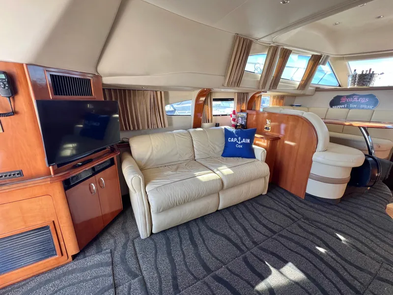 Slide: The Image of Luxurious interior of 2004 Carver 420 Mariner yacht with leather sofa and entertainment area. - 14