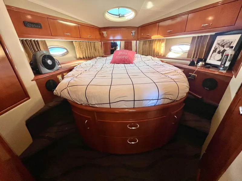 Slide: The Image of Luxurious bedroom interior of 2004 Carver 420 Mariner yacht with cozy bed and wooden cabinetry. - 25