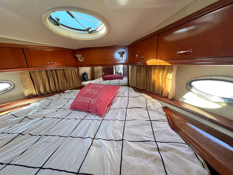 Slide: The Image of Luxurious cabin interior of 2004 Carver 420 Mariner with cozy bedding and porthole windows. - 31