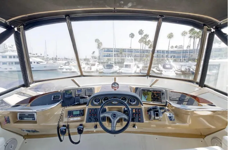 Slide: The Image of Helm of 2004 Carver 420 Mariner yacht with navigation equipment and marina view. - 35