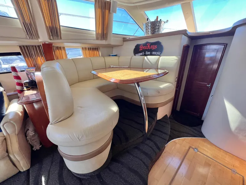 Slide: The Image of Luxurious interior of 2004 Carver 420 Mariner yacht with plush seating and elegant table. - 16
