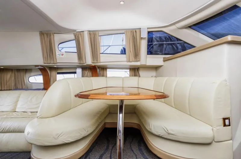 Slide: The Image of Luxurious interior of 2004 Carver 420 Mariner yacht with cream leather seating and wooden table. - 17