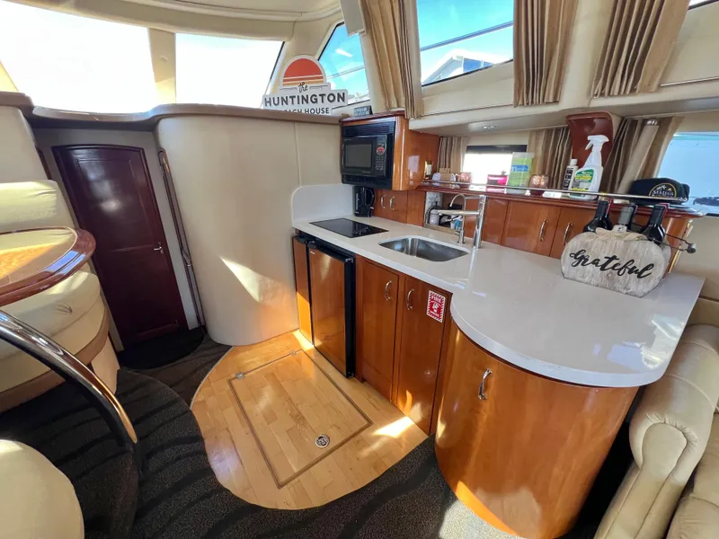 Slide: The Image of Luxurious interior of 2004 Carver 420 Mariner yacht with modern kitchen amenities. - 19