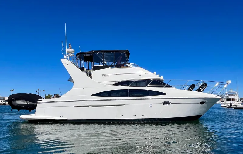 Slide: The Image of 2004 Carver 420 Mariner yacht on water under clear blue sky. - 2