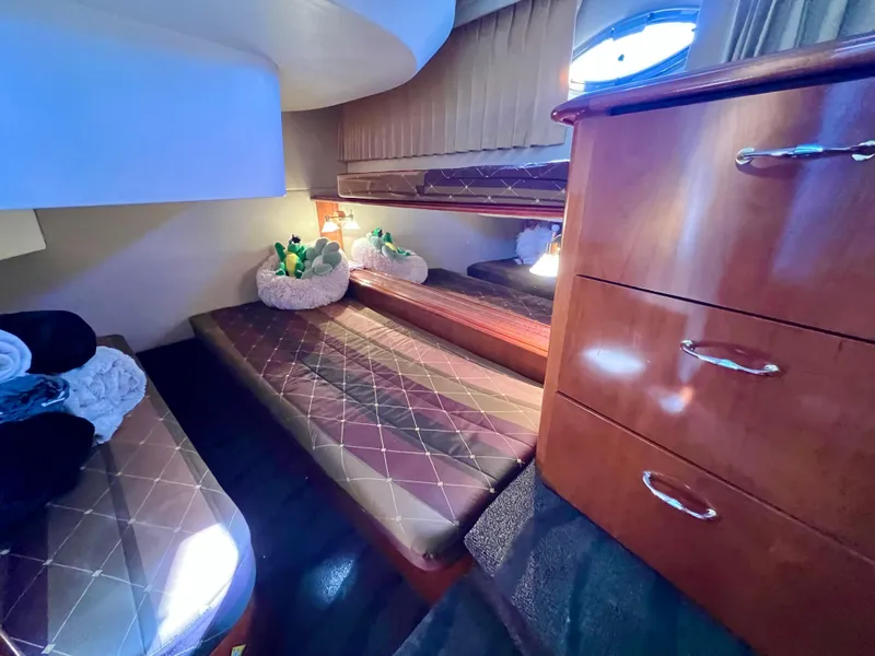 Slide: The Image of Luxurious cabin interior of 2004 Carver 420 Mariner yacht with cozy beds and wooden cabinetry. - 26