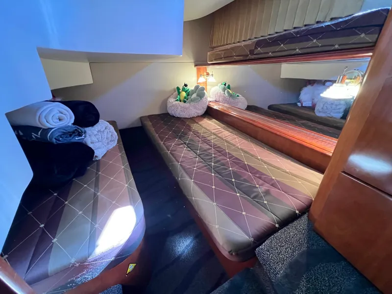 Slide: The Image of Cozy cabin interior of 2004 Carver 420 Mariner with twin beds and soft lighting. - 27