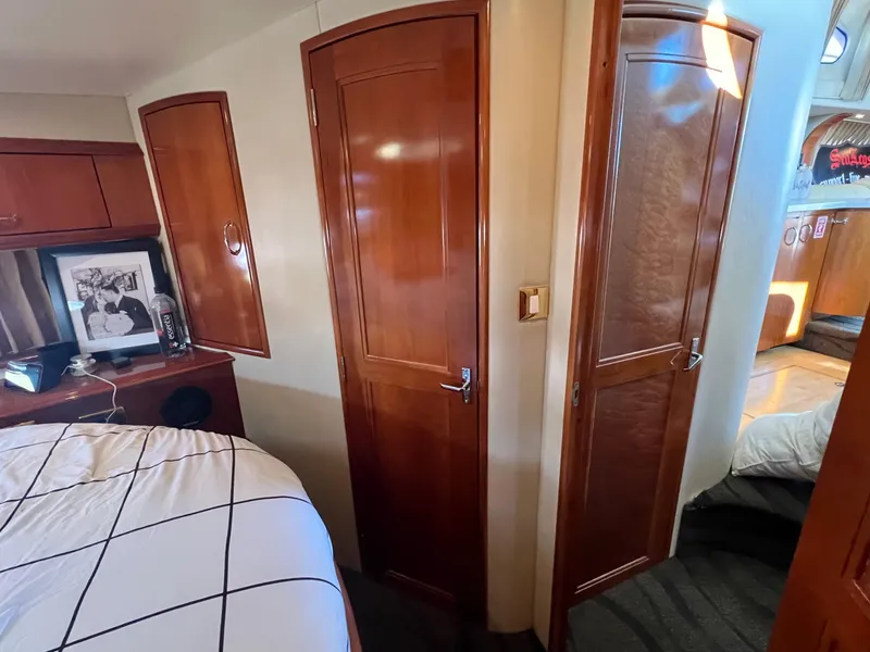 Slide: The Image of Interior of 2004 Carver 420 Mariner yacht with wooden doors and cozy bedroom. - 29