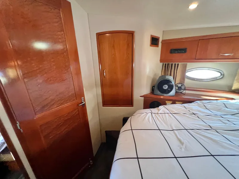 Slide: The Image of Interior of 2004 Carver 420 Mariner yacht bedroom with wood finishes and bed. - 30
