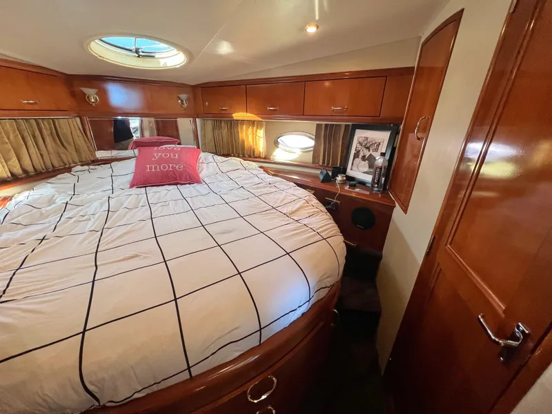 Slide: The Image of Luxurious cabin interior of 2004 Carver 420 Mariner yacht with cozy bed and wood finish. - 32