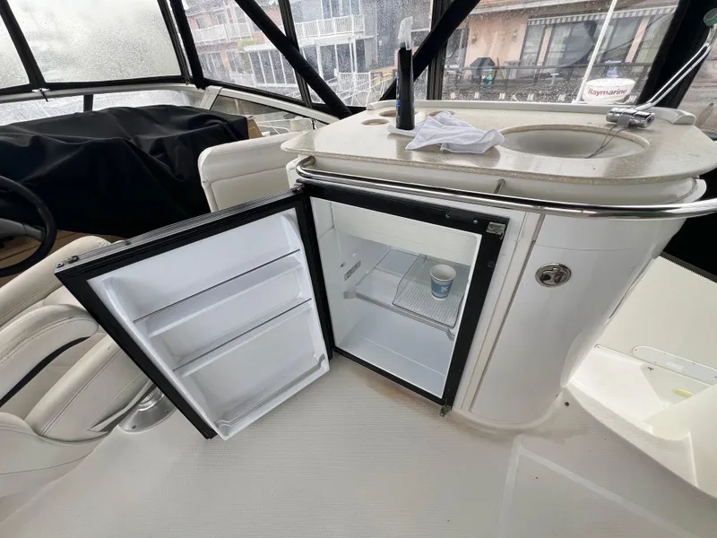 Slide: The Image of Open mini fridge and sink on 2004 Carver 420 Mariner yacht. - 36