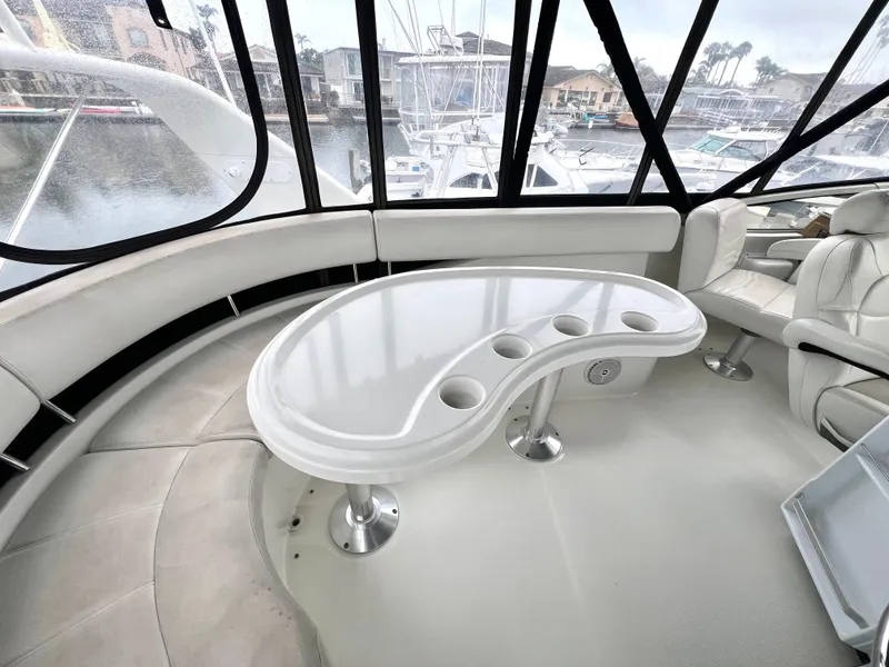 Slide: The Image of Interior of 2004 Carver 420 Mariner yacht with curved seating and table, docked at marina. - 37