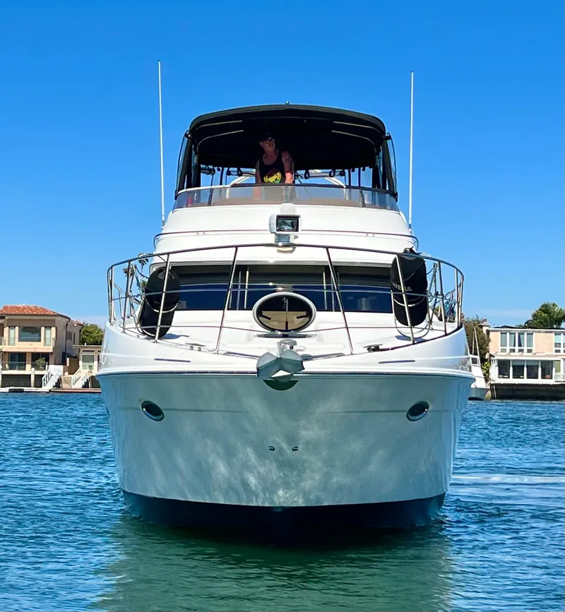Slide: The Image of 2004 Carver 420 Mariner yacht on water, clear blue sky background. - 6