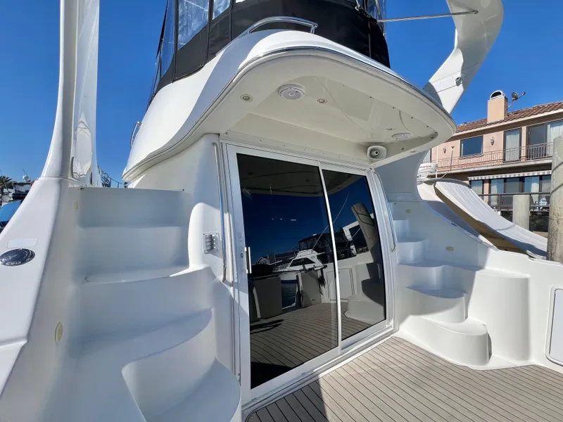 Slide: The Image of 2004 Carver 420 Mariner yacht with sleek design and modern features, docked at a marina. - 8