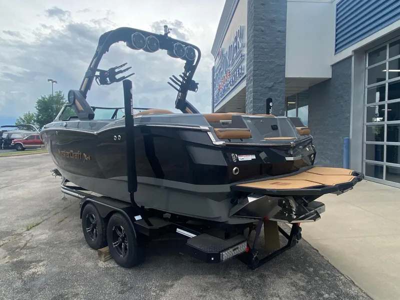 Slide: The Image of 2022 MasterCraft XStar boat on trailer outside dealership. - 8