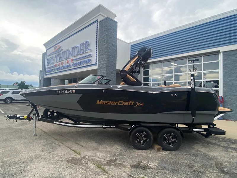 Slide: The Image of 2022 MasterCraft XStar boat on trailer at Big Thunder Marine dealership. - 9