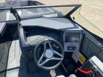 Slide: The Image of 2025 ATX Surf Boats 24 Type-S dashboard with steering wheel and touchscreen display. - 7